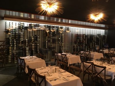 Wine racks and dining area of the Joe Muer Seafood restaurant where general contractor Roncelli, Inc. oversaw the project.
